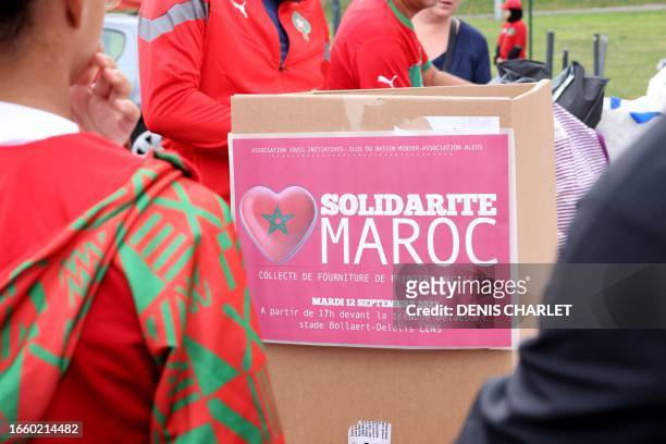 Volunteers collect donations for the victims of the earthquake in Morocco at a collection point on the sidelines of the international friendly...