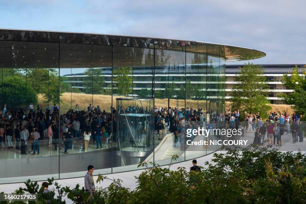 People walk through the Steve Jobs Theater prior to an event at the Apple Park campus in Cupertino, California, on September 12, 2023. The new Apple...