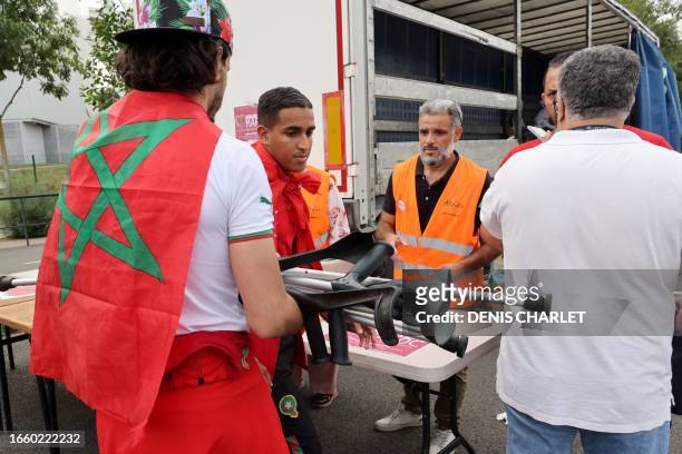 Moroccan football fan donates walking aides for the victims of the earthquake in Morocco at a collection point on the sidelines of the international...