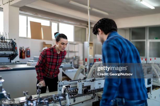two workers perform their official duties. - label printing stock pictures, royalty-free photos & images