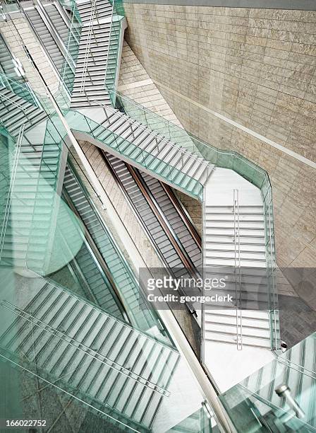 reflected modern architecture - winding stairs over straight escalators - grand angle stock pictures, royalty-free photos & images