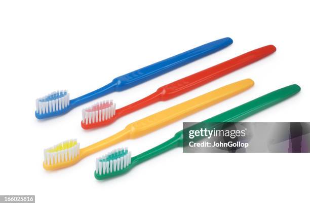 four colorful toothbrushes on a white background - tandborste bildbanksfoton och bilder