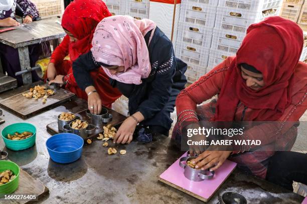 Women prepare to package dried figs at a processing facility in the village of Kurin in the rebel-held southern part of Syria's northwestern Idlib...