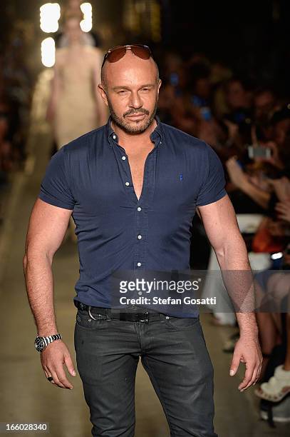 Designer Alex Perry walks the runway after the Alex Perry show during Mercedes-Benz Fashion Week Australia Spring/Summer 2013/14 at Carriageworks on...