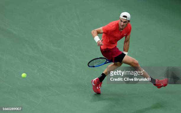 Jack Draper of Great Britain returns a shot between his legs against Andrey Rublev of Russia during their Men's Singles Fourth Round match on Day...