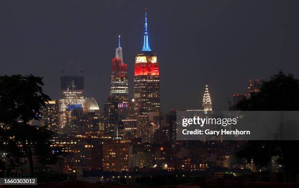 The Empire State Building and One Vanderbilt are lit in red, white, and blue to mark Labor Day in New York City on September 4, as seen from Jersey...