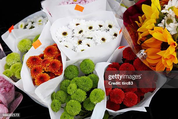colorful flowers for sale outside florist shop - flower bucket stock pictures, royalty-free photos & images