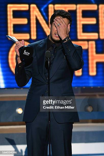 Co-host and recording artist Luke Bryan reacts as he accepts the Entertainer of the Year award onstage during the 48th Annual Academy of Country...