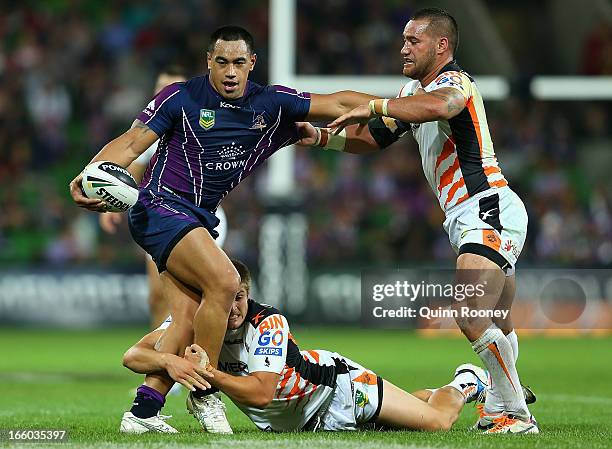 Mahe Fonua of the Storm is tackled by Blake Ayshford of the Tigers during the round 5 NRL match between the Melbourne Storm and the Wests Tigers at...