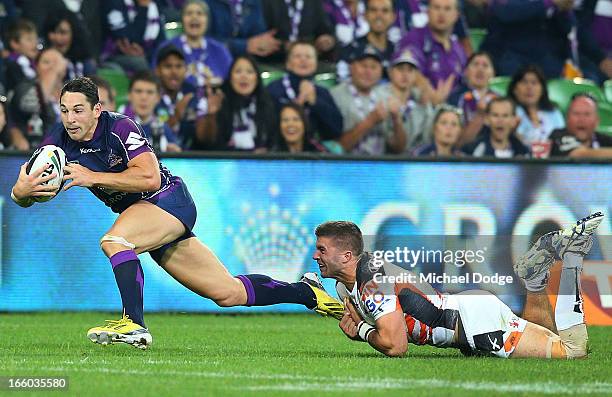 Billy Slater of the Storm gets tackled by James Tedesco of the Tigers during the round 5 NRL match between the Melbourne Storm and the Wests Tigers...