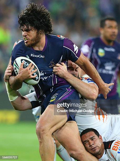 Tohu Harris of the Storm gets tackled during the round 5 NRL match between the Melbourne Storm and the Wests Tigers at AAMI Stadium on April 8, 2013...