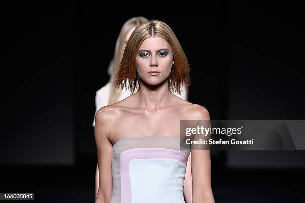 Model showcases designs on the runway at the By Johnny show during Mercedes-Benz Fashion Week Australia Spring/Summer 2013/14 at Carriageworks on...