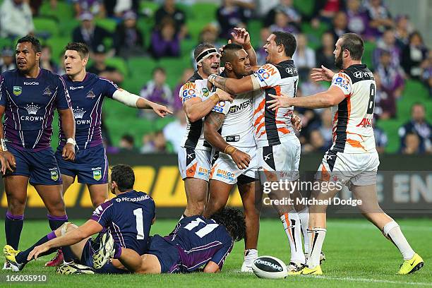 Tigers players react after Eddie Pettybourne scored a try that was later turned down during the round 5 NRL match between the Melbourne Storm and the...