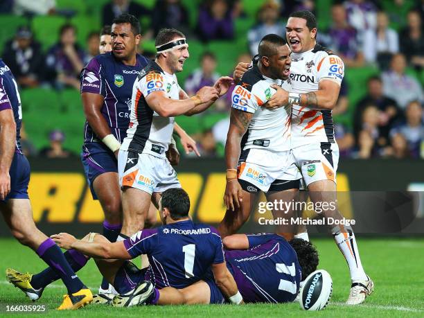 Tigers players Robbie Farah and Ben Murdoch-Masila react after Eddie Pettybourne scored a try that was later turned down during the round 5 NRL match...