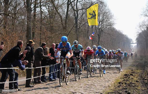 Johan Van Summeren of Belgium and Garmin-Sharp leads the peloton through the Arenberg Forest during the 2013 Paris - Roubaix race from Compiegne to...
