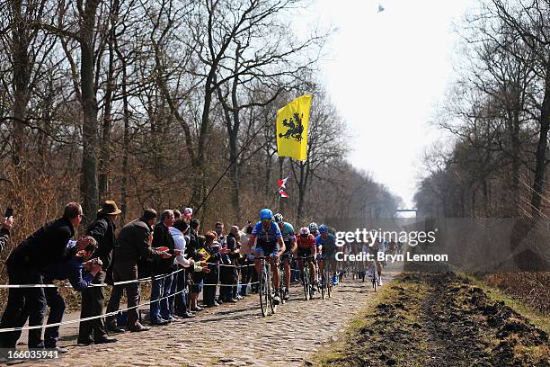 Johan Van Summeren of Belgium and Garmin-Sharp leads the peloton through the Arenberg Forest during the 2013 Paris - Roubaix race from Compiegne to...