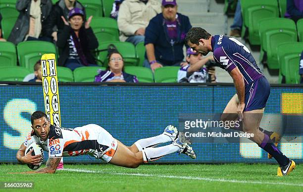 Benji Marshall of the Tigers scores a try past Cameron Smith of the Storm during the round 5 NRL match between the Melbourne Storm and the Wests...