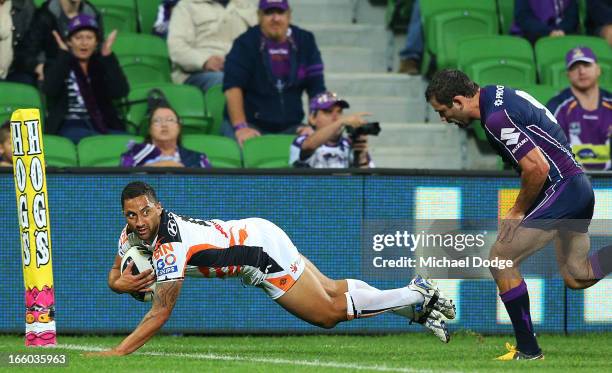 Benji Marshall of the Tigers scores a try past Cameron Smith of the Storm during the round 5 NRL match between the Melbourne Storm and the Wests...