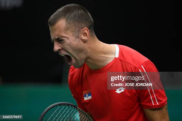 Serbia's Laslo Djere reacts to beating South Korea's Kwon Soon-woo during the group stage men's singles match between Serbia and South Korea of the...