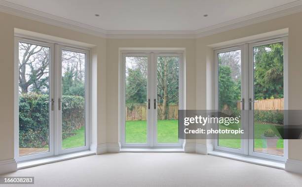 bay window patio doors - bay window interior stock pictures, royalty-free photos & images