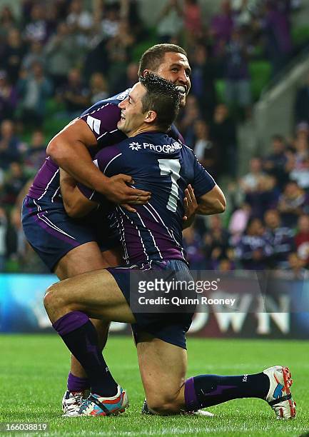 Cooper Cronk of the Storm is congratulated by Kenny Bromwich after scoring a try during the round 5 NRL match between the Melbourne Storm and the...