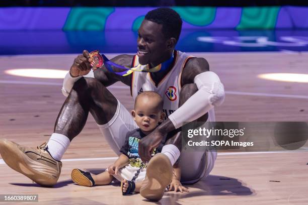 Dennis Schroder of Germany celebrates with his son after winning the finals of the FIBA Basketball World Cup 2023 between Serbia and Germany at the...