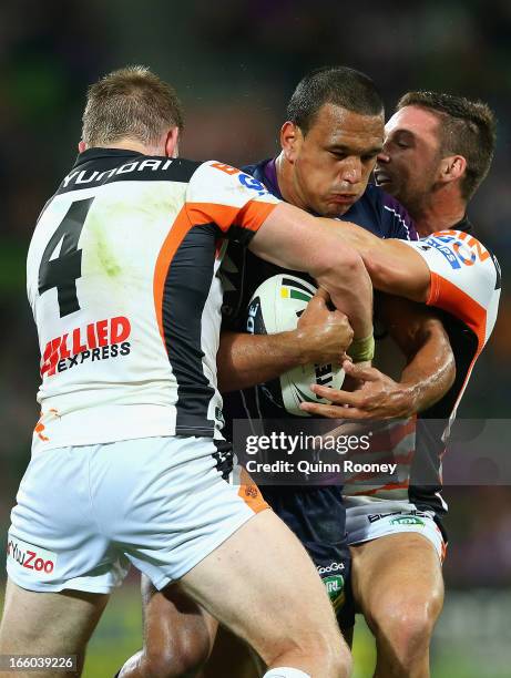 Will Chambers of the Storm is tackled by Chris Lawrence of the Tigers during the round 5 NRL match between the Melbourne Storm and the Wests Tigers...