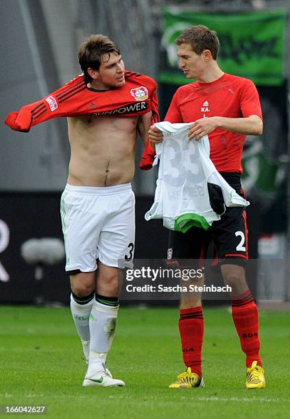 Patrick Helmes of Wolfsburg and Daniel Schwaab of Leverkusen swap jerseys after the Bundesliga match between Bayer 04 Leverkusen and VfL Wolfsburg at...