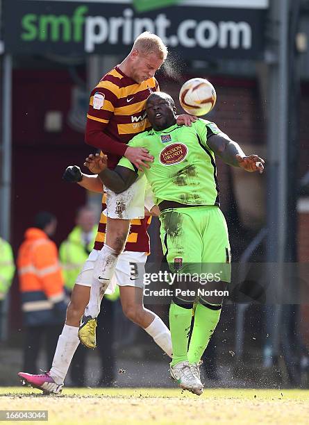 Andrew Davies of Bradford City contests the ball with Adebayo Akinfenwa of Northampton Town during the npower League Two match between Bradford City...