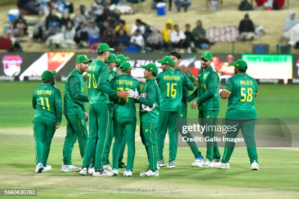 Gerald Coetzee of South Africa celebrates the dismissal of Tim David with his teammates during the 3rd Betway One Day International match between...