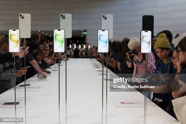 Attendees look at brand new Apple products during an Apple event at the Steve Jobs Theater at Apple Park on September 12, 2023 in Cupertino,...