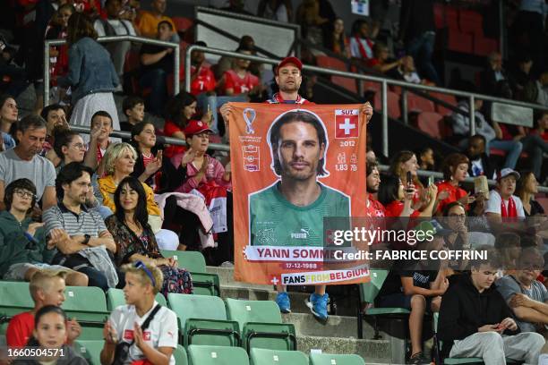 Supporter holds a banner depicting Switzerland's goalkeeper Yann Sommer prior to the start of the UEFA Euro 2024 football tournament Group I...