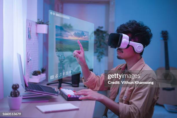 man wearing virtual headset and working on futuristic graphic. - virtual reality point of view stock pictures, royalty-free photos & images