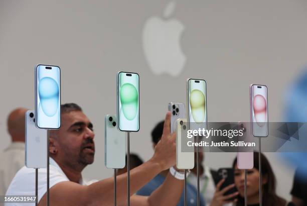 Attendees look at the brand new Apple iPhone 15 during an Apple event on September 12, 2023 in Cupertino, California. Apple revealed its lineup of...
