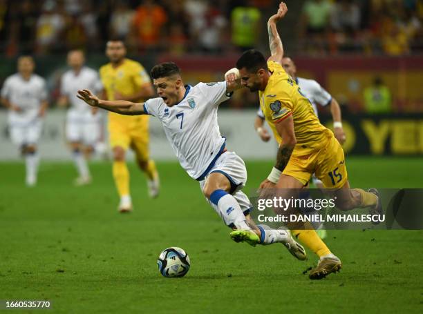 Kosovo's midfielder Milot Rashica and Romania's defender Andrei Burca vie for the ball during the EURO 2024 first round group I qualifying football...