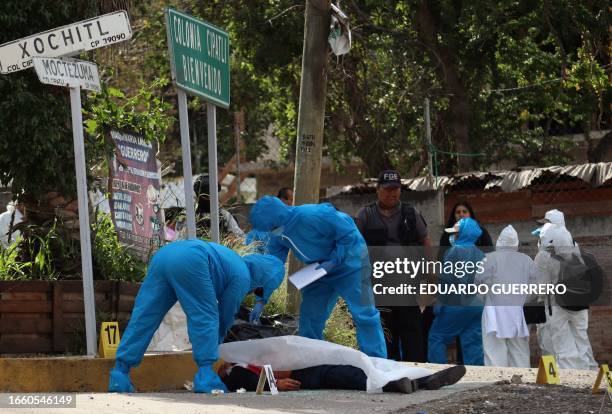 Graphic content / Members of the local prosecutor's office work at the site of the murder of Fernando Garcia Hernandez, a delegate of the Attorney...