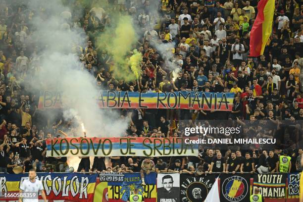 Romanian ultras display a banners reading "Kosovo is Serbia" and "Bessarabia is Romania" during the EURO 2024 first round group I qualifying football...