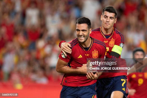 Spain's midfielder Mikel Merino celebrates scoring his team's second goal, with Spain's forward Alvaro Morata, during the EURO 2024 first round group...