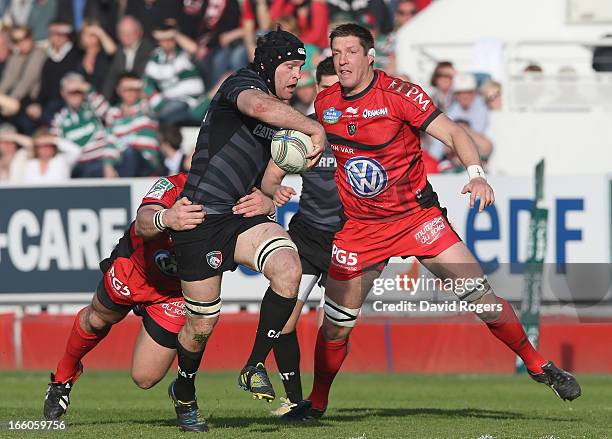 Julien Salvi of Leicester is tackled by Andrew Sheridan and Bakkies Botha during the Heineken Cup quarter final match between Toulon and Leicester...
