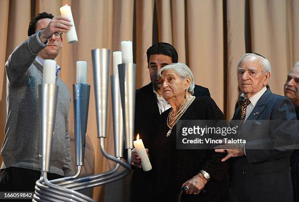 David Rybowski, and his wife Zenia Rybowski ,when lighting the first candle at the ceremony , both 89 years old and both Holocaust survivors and...