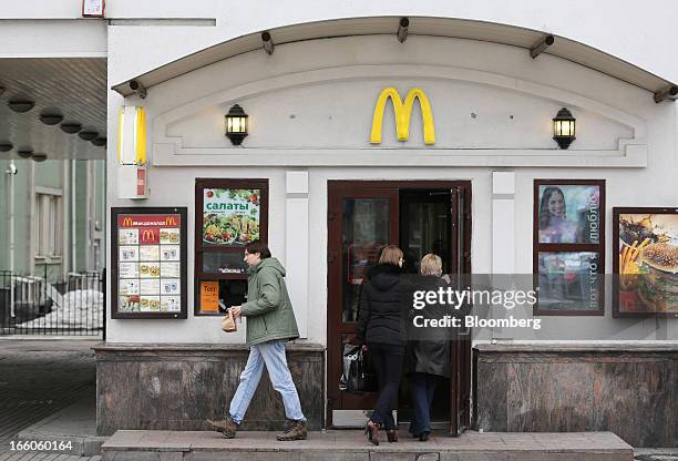 Customers enter and exit a McDonald's food restaurant in Moscow, Russia, on Sunday, April 7, 2013. McDonald's Corp., which virtually created the...