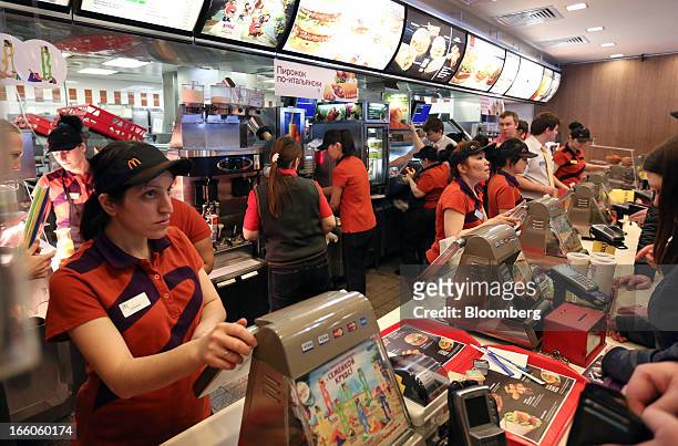 Employees serve customers at the service counter of a McDonald's food restaurant in Moscow, Russia, on Sunday, April 7, 2013. McDonald's Corp., which...