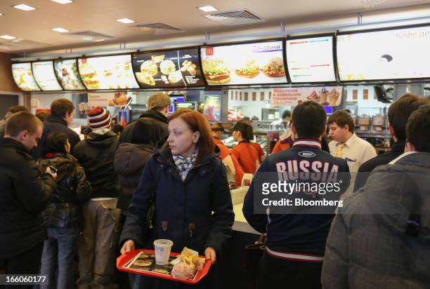 Customer collects a tray of food at the service counter of a McDonald's food restaurant in Moscow, Russia, on Sunday, April 7, 2013. McDonald's...