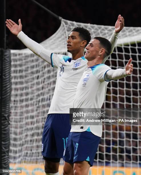 England's Jude Bellingham celebrates scoring his sides second goal with team mate Phil Foden during the international friendly match at Hampden Park,...