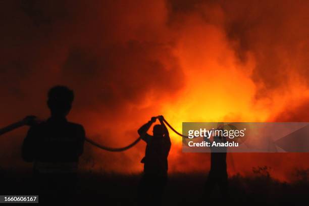 Indonesian police officers try to extinguish wildfire in Ogan Ilir, South Sumatera, Indonesia on September 12, 2023. Southeast Asia could see the...