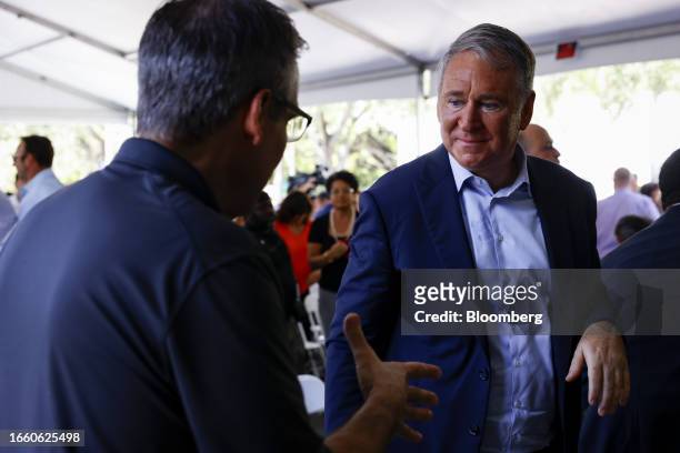 Ken Griffin, chief executive officer and founder of Citadel Advisors LLC, right, greets an attendee during a ground breaking ceremony for the final...