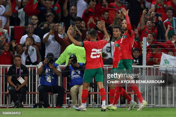 Morocco's defender Yahia Attiyat Allah, Morocco's forward Youssef En-Nesyri celebrate with Morocco's midfielder Azzedine Ounahi after he scored...