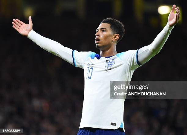 England's midfielder Jude Bellingham celebrates scoring the team's second goal during the international friendly football match between Scotland and...