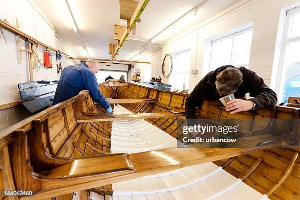 team varnishing a gig boat - shipbuilder stock pictures, royalty-free photos & images