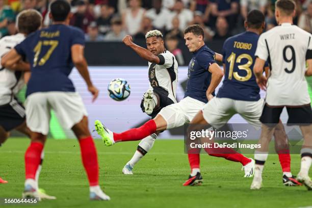 Serge Gnabry of Germany and Benjamin Pavard of France battle for the ball during the international friendly match between Germany and France at...